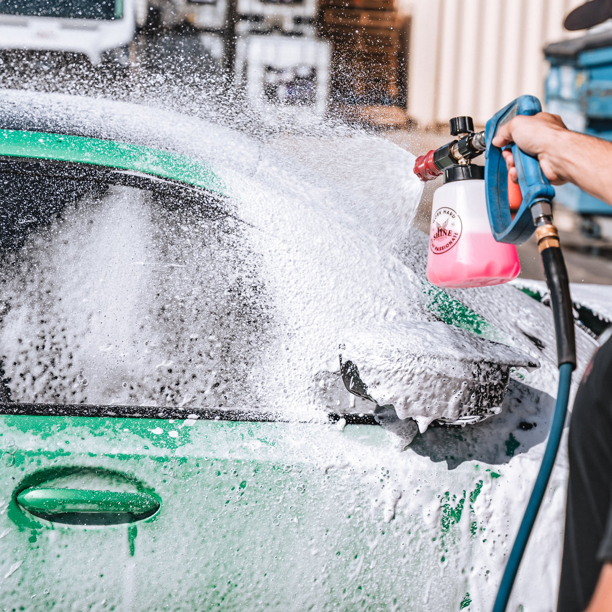 The Foam Thrower foam cannon spraying thick foam across the rear of a green car