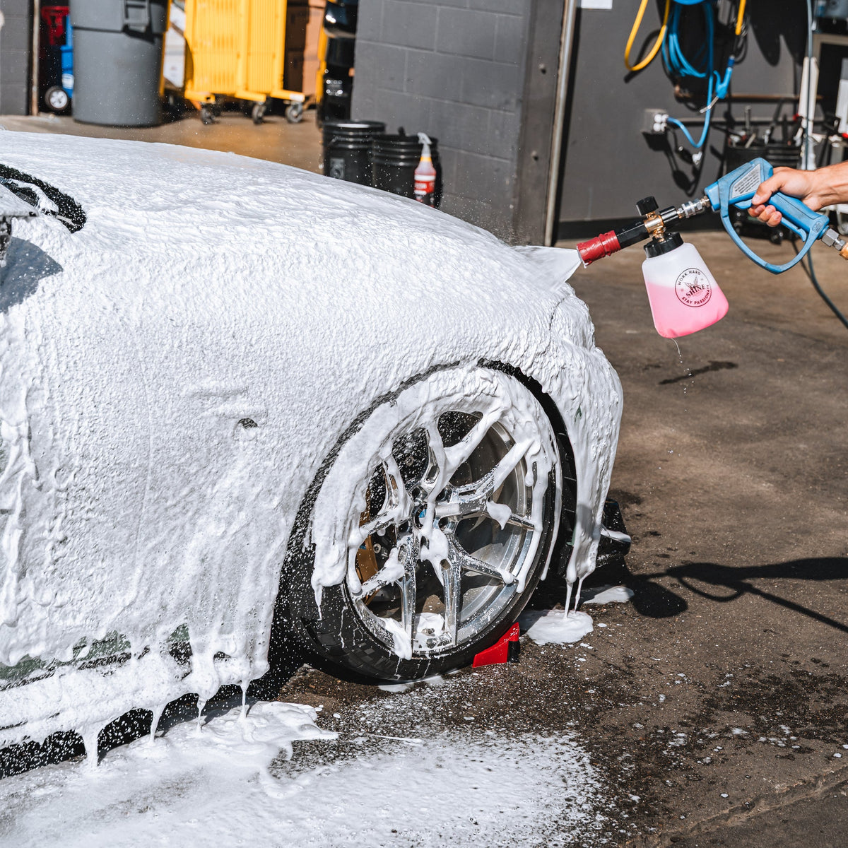Sports car covered in thick foam from The Foam Thrower foam cannon during a wash