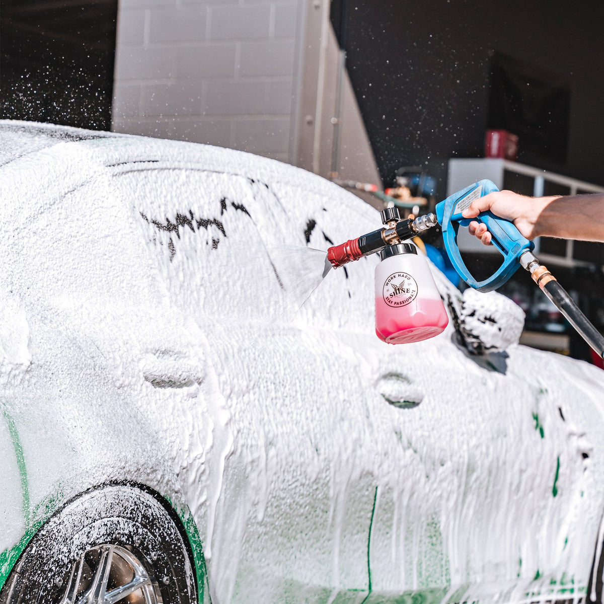 Thick shaving-cream foam blanketing a car hood from The Foam Thrower foam cannon