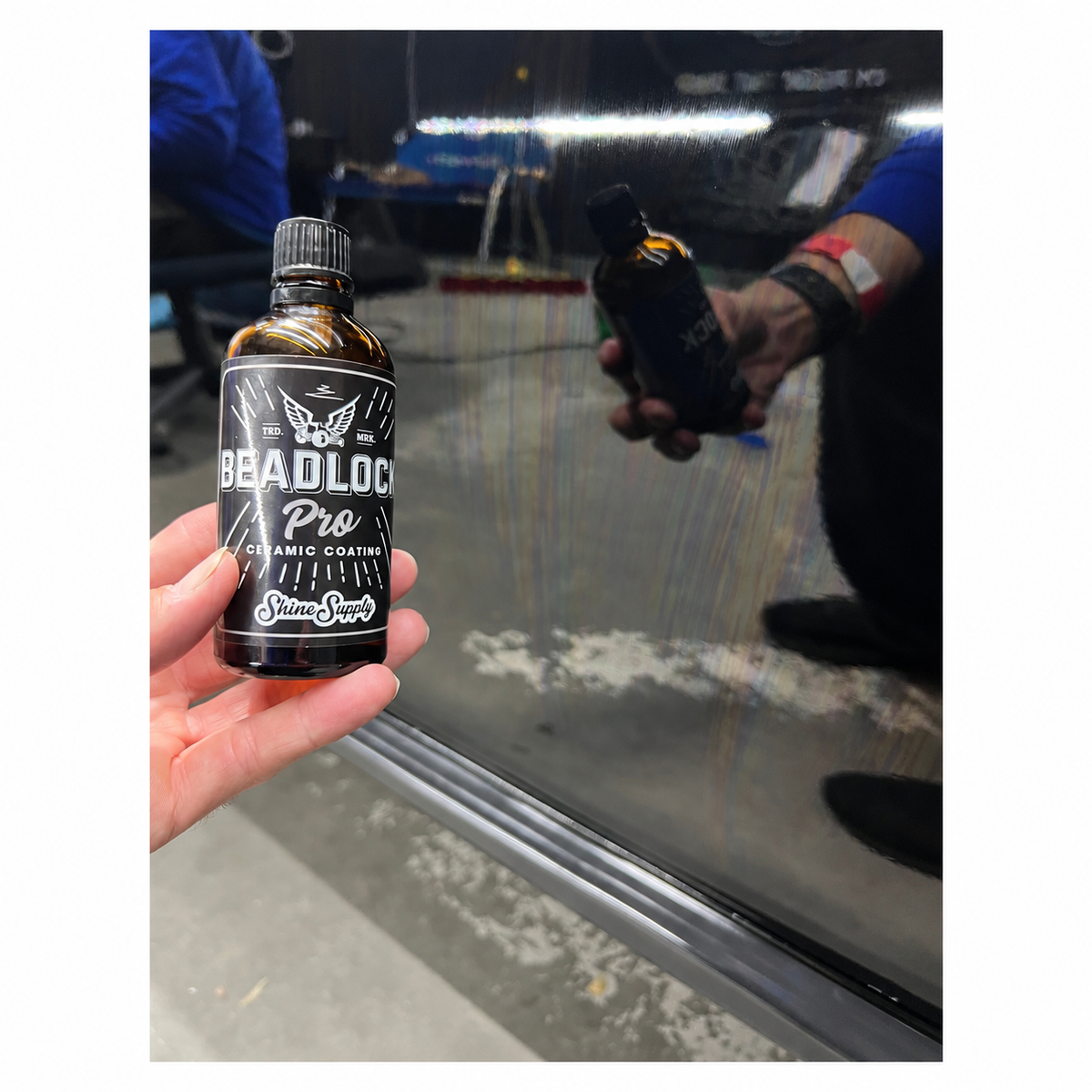 Applying Beadlock Pro 9H ceramic paint coating to a vehicle panel with a coating applicator