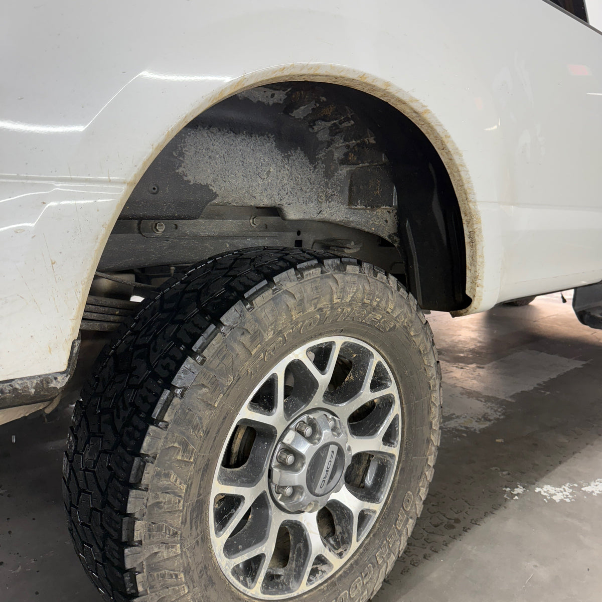 Dirty wheel well before Classy Chassis undercarriage spray