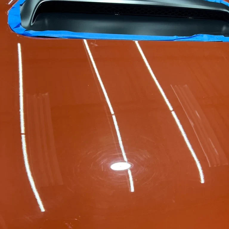 Scratches and swirl marks on orange paint before Burn Out reconditioning cream